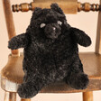 Jellycat Amore Cat Black Small Soft Toy Sitting on Wooden Chair with Natural Coloured Background