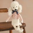 Jellycat Beatnik Buddy Poodle Soft Toy Sitting on Wooden Chair