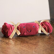 Jellycat Small Festive Folly Cracker Soft Toy on Wooden Chair