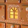 Close Up of Window From Wooden Gingerbread House LED Advent Calendar Lit Up in the Dark