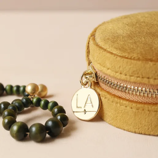 Mustard Velvet Round Travel Jewellery Case Alongside Green and Gold Earrings