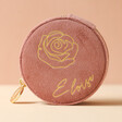 Rose Pink Personalised Birth Flower Velvet Round Travel Jewellery Case in Front of Neutral Background