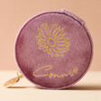 Mauve Pink Personalised Birth Flower Velvet Round Travel Jewellery Case in Front of Neutral Background