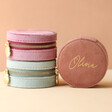 Personalised Velvet Round Travel Jewellery Cases Stacked in Front of Neutral Background