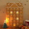 Wooden Gingerbread House LED Advent Calendar With Cut-Out Inserted Lit Up in the Dark