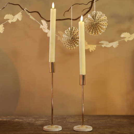 Set of 2 Cream LED Candles Turned on Against Decorative Background