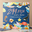 Fish and a Diver 300 Piece Jigsaw Puzzle Up Against Natural Coloured Background with Puzzle Pieces Surrounding