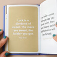 Model Holding You Make Me Proud Book Open with Inspirational Quote on Gold Page