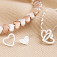 Silver Heart Stud Earrings, Necklace and Beaded Bracelet Set on Beige Fabric