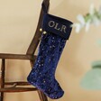 Navy Blue Personalised Large Starry Velvet Christmas Stocking Hanging from Chair
