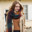 Model Wearing Thick Burgundy, Navy and Mustard Winter Scarf over Orange Jumper