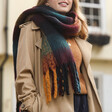 Close Up of Model Wearing Thick Burgundy, Navy and Mustard Winter Scarf over Brown Coat