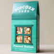 Popcorn Shed Peanut Butter Gourmet Popcorn in Packaging with Neutral Background