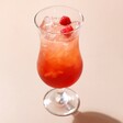 Piña  Colada Cocktail Glass with Cocktail Inside on Neutral Backdrop