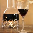 Crystal Cut Orchestra Wine Glass Filled with Red Wine
