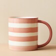 Back of Pink and White Striped Mug on Cream Background