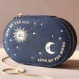 Sun and Moon Embroidered Oval Jewellery Case in Navy on its Side on a Neutral Coloured Background