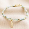 Amazonite Stone Bracelet with Feather Charm in Gold on Cream Fabric