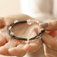 Model Holding Grey Leather Layered Heart Bracelet in Silver in Palm of Hand
