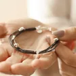 Model Holding Grey Leather Layered Heart Bracelet in Silver in Palm of Hand