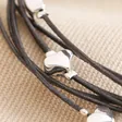 Close Up of Silver Heart Beads on Grey Leather Layered Heart Bracelet in Silver