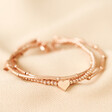 Heart Beaded Triple Layered Bracelet in Rose Gold on Beige Fabric