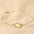 Personalised Birth Flower Crystal Edge Disc Bracelet in Gold on Neutral Fabric