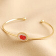 December Pressed Birth Flower Bangle in Gold on Neutral Coloured Fabric