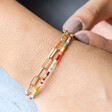 Model Wearing Rainbow Glass Bead and Chain Bracelet in Gold