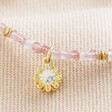 Close Up of Charm on Strawberry Quartz Stone Bracelet with Daisy Charm in Gold