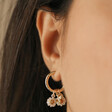 Close Up of Daisy and Bee Charms on Daisy, Pearl and Bee Charm Hoop Earrings in Gold
