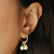 Model Wearing Pearl and Bee Charms on Daisy, Pearl and Bee Charm Hoop Earrings in Gold
