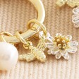 Close Up of Daisy, Pearl and Bee Charm Hoop Earrings in Gold