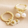 Mix and Match Daisy, Pearl and Bee Charm Hoop Earrings in Gold on Beige Fabric