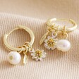Daisy, Pearl and Feather Hoop Earrings in Gold on Beige Coloured Fabric