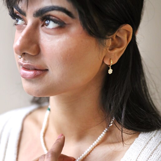 White Enamel Celestial Bee Charm Huggie Hoop Earrings in Gold on Model