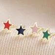 Mismatched Pack of 4 Enamel Star Stud Earrings in Gold on Beige Fabric
