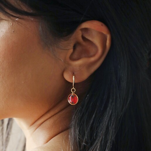 Close Up of Model Wearing Pressed Birth Flower Huggie Hoop Earrings in Gold 