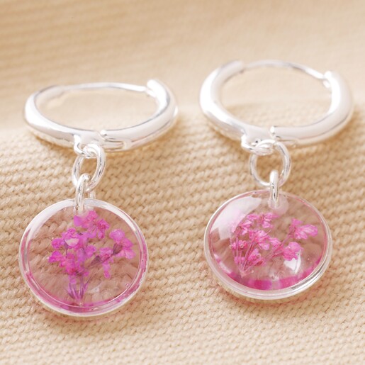 January Charm of Pressed Birth Flower Huggie Hoop Earrings in Silver on Natural Coloured Fabric