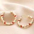 Red, White and Pink Twisted Enamel Hoop Earrings in Gold on Cream Fabric