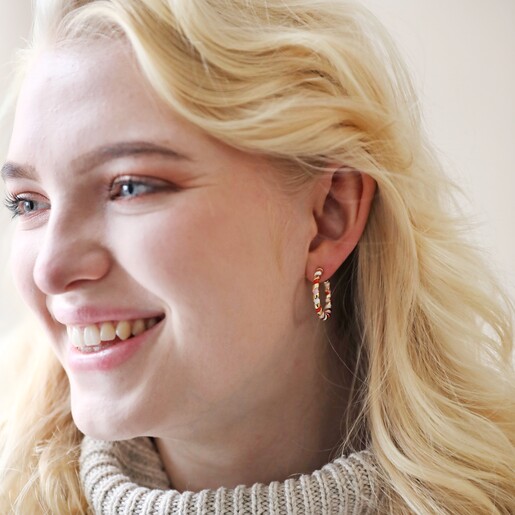 Red, White and Pink Twisted Enamel Hoop Earrings in Gold on Model Smiling