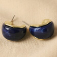 Small Navy Resin Hoop Earrings in Gold on Beige Fabric