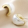 Small Pearlescent Hoop Earrings in Gold on Natural Coloured Fabric