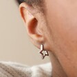 Close Up of Star Shape Huggie Hoop Earrings in Silver on Model