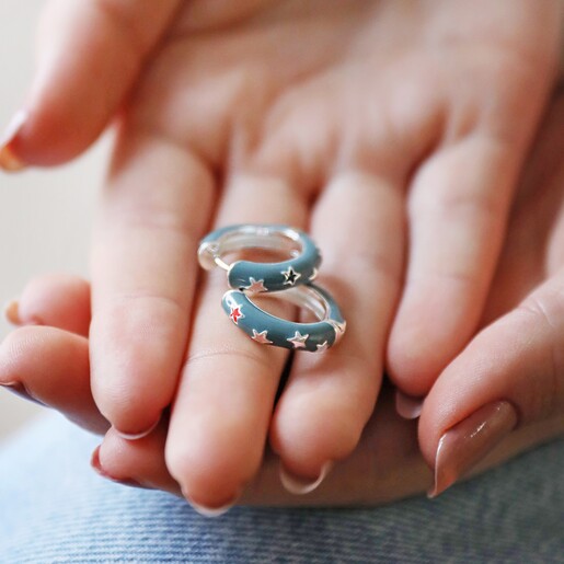 Model Holding Starry Blue Enamel Hoop Earrings in Hands