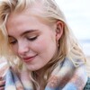 Model Wearing Strawberry Quartz Stone Huggie Hoop Earrings in Gold