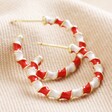 Red and White Twisted Enamel Hoops in Gold on Cream Fabric