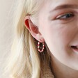 Model Wearing Red and White Twisted Enamel Hoops in Gold Close Up