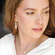 Model Wears Freshwater Pearl Loop Earrings in Gold with Gold Pearl Necklace