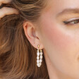 Model Wearing Freshwater Pearl Loop Earrings in Gold